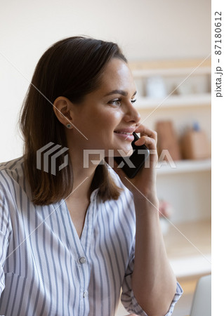 Smiling millennial attractive woman holding smartphone call talk. 87180612
