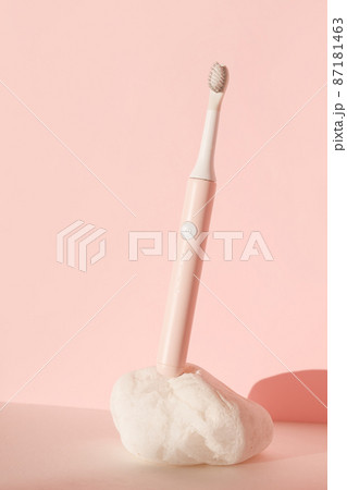 New modern ultrasonic toothbrush. Dental care supplies on white stone on pink pastel background. Oral hygiene, dental and gum health, healthy teeth. Dental products Ultrasonic vibration toothbrush. New modern ultrasonic toothbrush. Dental care supplies on white stone on pink pastel background. Oral hygiene, dental and gum health, healthy teeth. Dental products Ultrasonic vibration toothbrush. 87181463