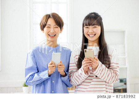 親子でスマホを持つ　母親 87183992