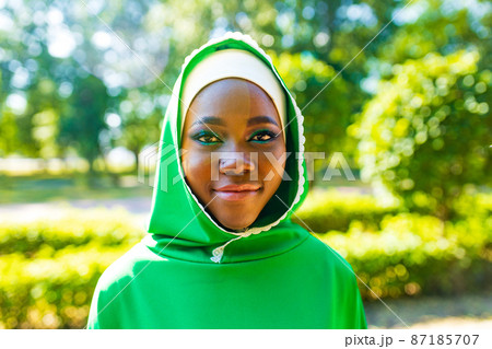 Beautiful modern student woman in hijab with make-up and piercing ring on the nose outdoor Beautiful modern student woman in hijab with make-up and piercing ring on the nose outdoor 87185707