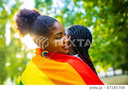 brazilian lesbian couple in white dress spending time together celebrating engagement in summer park outdoor 87185708
