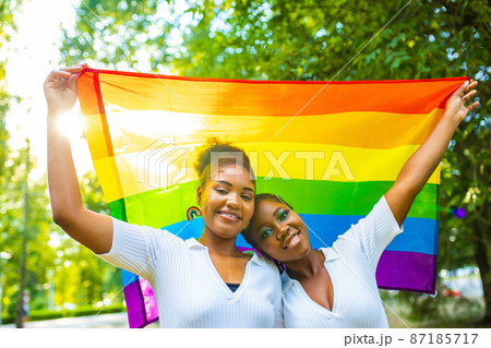 brazilian lesbian couple in white dress spending time together celebrating engagement in summer park outdoor brazilian lesbian couple in white dress spending time together celebrating engagement in summer park outdoor 87185717