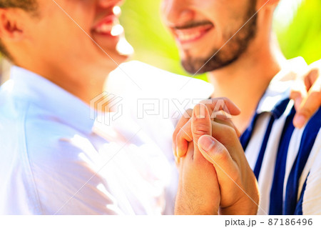 Gay couple together spending moments of happiness in green park Gay couple together spending moments of happiness in green park 87186496