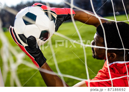 brazilian man goalkeeper catches the ball in the stadium during a football training 87186692