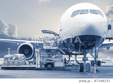 loading cargo on airplane, picture in a blue toning 87188255