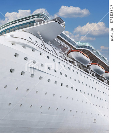 Cruise ship side view with blue sky. Vacation on ocean liner concept Cruise ship side view with blue sky. Vacation on ocean liner concept 87188317