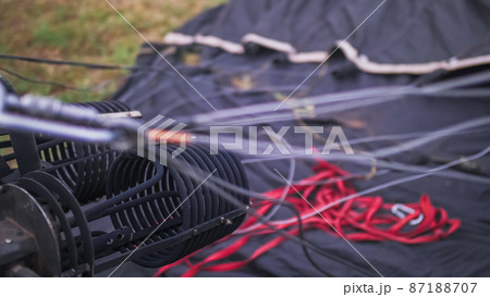 Adventure on hot air balloon watermelon. Burner directing flame into envelope and cold air by ventilating fan blower. Hot air balloon or aerostat. 87188707