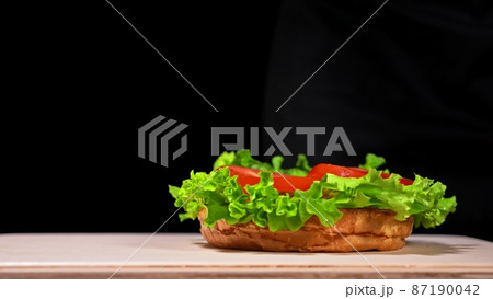 Craft burger is cooking. Consist: red sauce salsa, lettuce, red onion, pickle, cheese, chilli green pepper, air bun and marbled meat beef. 87190042