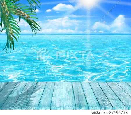 夏の太陽の光差し込む雲のある青い空の下ウッドデッキとヤシの木と海のゆらめく波の美しいフレーム素材 87192233