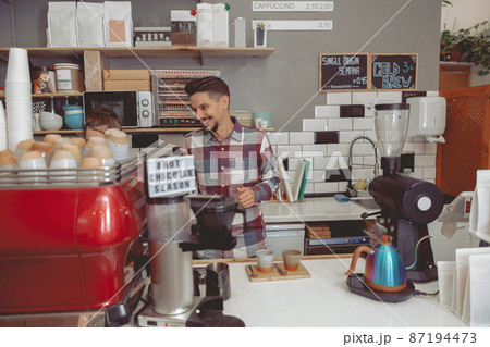 Photo of counter in modern cafe shop with people working there Photo of counter in modern cafe shop with people working there 87194473