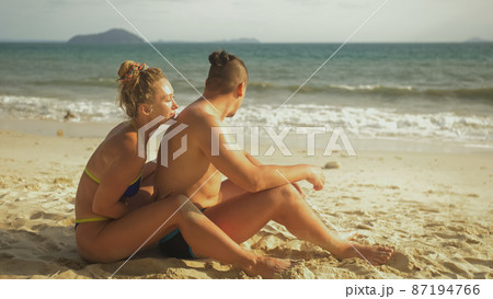 Hot sexy loving couple having sun block. Woman to put sunscreen 87194766