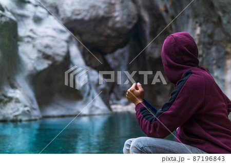 man on a boat floats through a deep rocky canyon 87196843