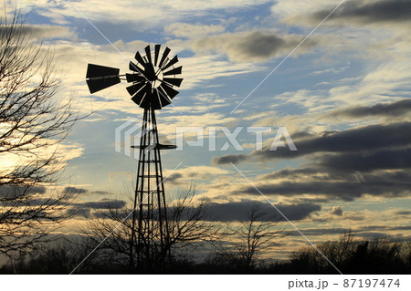 Kansas colorful Sunset with clouds and trees out in the country that's bright and colorful. 87197474