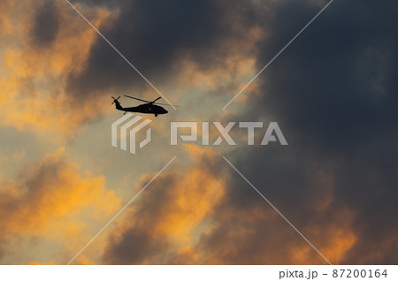 夕暮の中を飛行するヘリコプター 夕暮の中を飛行するヘリコプター 87200164