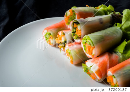 Fresh vegetable salad roll in noodle tube on dish isolated on white background 87200187