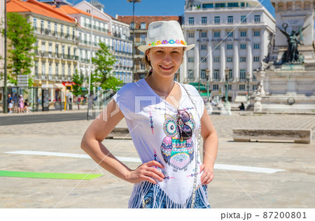 Young beautiful woman traveler with white hat on vacation 87200801