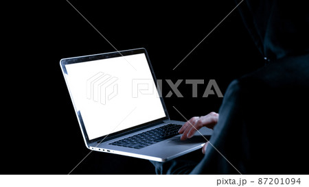 Cyber attack hacker concept. Internet web hack technology. Digital laptop in hacker man hand isolated on black. Data protection, secured internet access, cybersecurity banner. 87201094