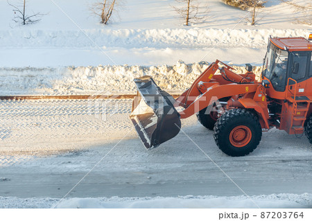 Cleaning and cleaning of roads in the city from snow in winter Cleaning and cleaning of roads in the city from snow in winter 87203764
