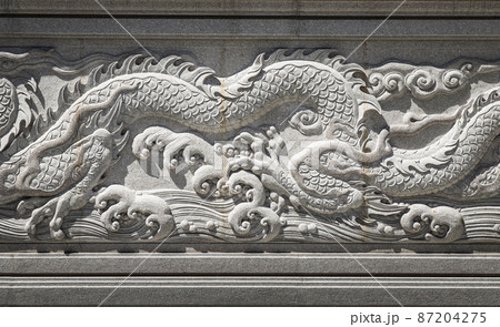 Elaborate sculptured white chinese dragons on concrete wall of Fo Guang San Temple. 87204275