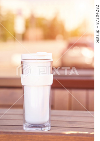 Drink beverage outdoors. Buy takeaway coffee in own cup. Ecology concept 87204282