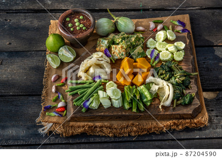 Thai Traditional Local Food : Spicy Shrimp Paste Dip or Fried shrimp paste sauce (Nam Prik Kapi) with blanched vegetables and cha-om omelets on wooden backgroud. Thai Traditional Local Food : Spicy Shrimp Paste Dip or Fried shrimp paste sauce (Nam Prik Kapi) with blanched vegetables and cha-om omelets on wooden backgroud. 87204590