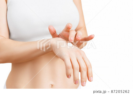 Woman applying cream, female hands, white, closeup. Woman applying cream, female hands, white, closeup. 87205262