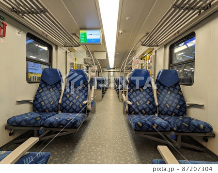 Empty blue seats inside polish train 87207304
