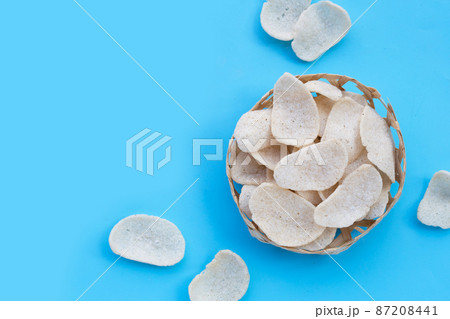 Prawn crackers on blue background. Shrimp crispy rice snack Prawn crackers on blue background. Shrimp crispy rice snack 87208441
