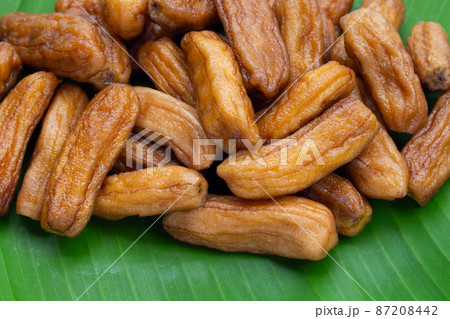 Sun-dried bananas on banana leaf Sun-dried bananas on banana leaf 87208442