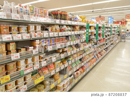 食品酒類飲料シャンプー歯磨き雑貨などが整然と並べられたスーパーマーケットの陳列棚 87208837