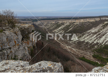 View of valley and mountain Besh-Kosh from plateau Burunchak near cavetown Chufut-Kale. Bakhchysarai, Crimea 87212751