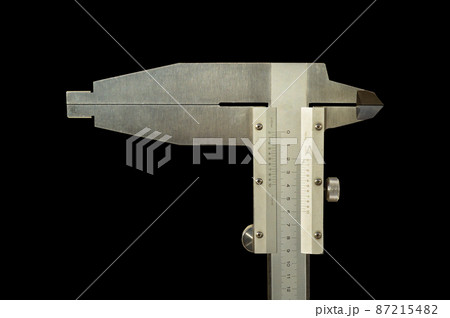 Analogue vernier calliper made of stainless steel for precise measurements, isolated on black background 87215482