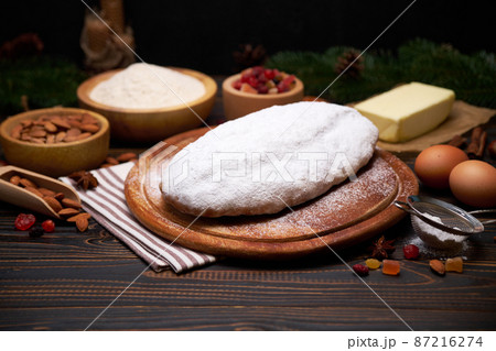 Traditional Christmas stollen cake recipe with ingredients isolated on wooden background Traditional Christmas stollen cake recipe with ingredients isolated on wooden background 87216274