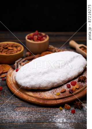 Traditional Christmas stollen cake recipe with ingredients on wooden background Traditional Christmas stollen cake recipe with ingredients on wooden background 87216275