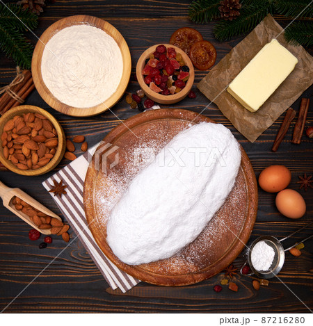 Traditional Christmas stollen cake recipe with ingredients isolated on wooden background Traditional Christmas stollen cake recipe with ingredients isolated on wooden background 87216280