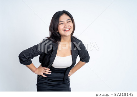 young asian woman standing with hands on waist young asian woman standing with hands on waist 87218145