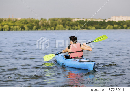 rear view man using paddle kayaking rear view man using paddle kayaking 87220114