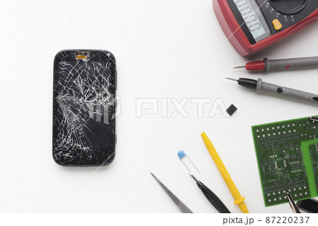 top view broken phone with electronic tools 87220237