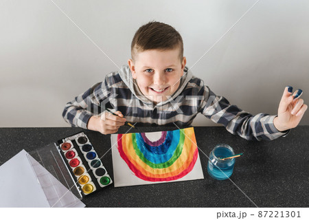 Schoolboy Painting Rainbow Picture with Brushes Schoolboy Painting Rainbow Picture with Brushes 87221301