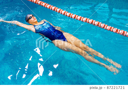 Young professional swimmer woman swimming in indoor pool  87221721