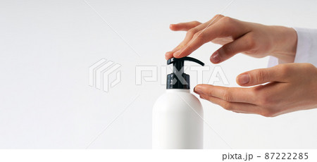 Woman hands pushing pump plastic soap bottle with copy space, using wash hand sanitizer gel pump dispenser. killing germs, bacteria and virus 87222285