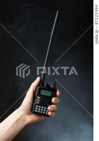 professional walkie-talkie radio in hand in smoke 87222494