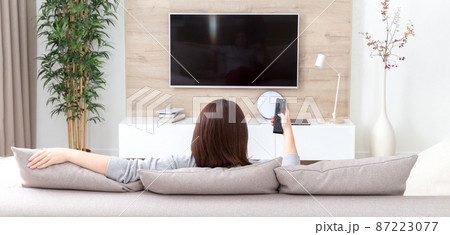 Young woman watching TV in the room 87223077