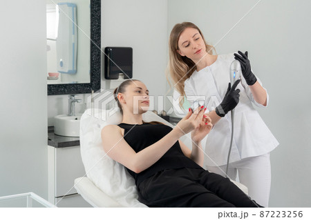 Young woman receiving laser treatment in cosmetology clinic 87223256