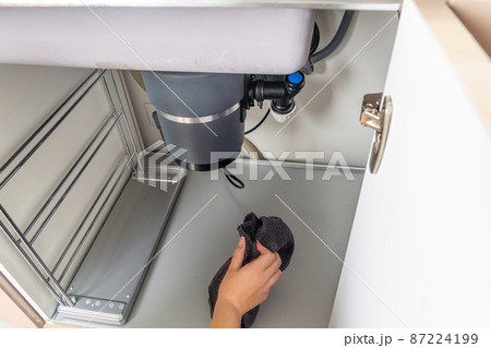 Waste disposal leak under a sink, broken garbage chopper 87224199