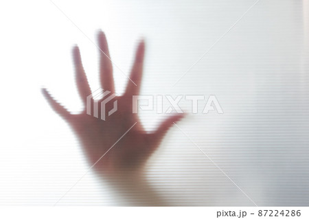 Diffused silhouette of female hands through plastic 87224286