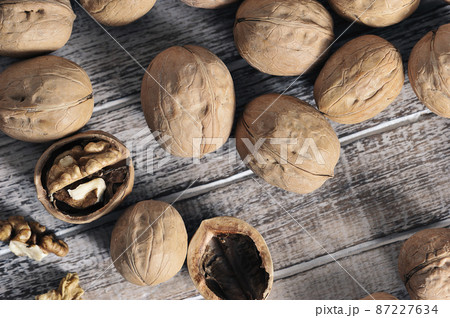 walnuts in a shell on a wooden background - top view walnuts in a shell on a wooden background - top view 87227634