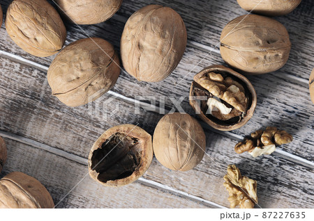 walnuts in a shell on a wooden background - top view 87227635