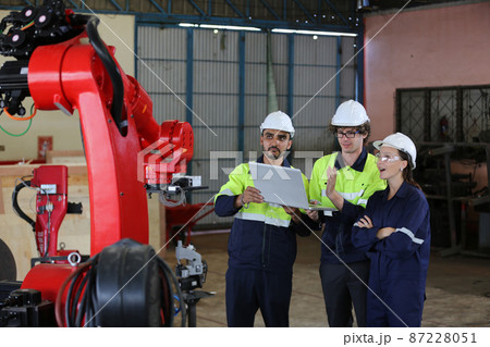 engineer checking control panel and teaching new Automatics robot arm and operating control machine in factory. engineer checking control panel and teaching new Automatics robot arm and operating control machine in factory. 87228051