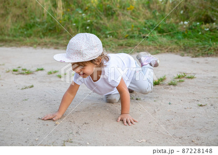 little toddler crawling in sand in counrtyside little toddler crawling in sand in counrtyside 87228148